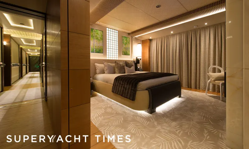 A guest stateroom aboard Nirvana, showing the warm timber and layered lighting of Sorgiovanni's interior work on the 2012 Oceanco delivery.