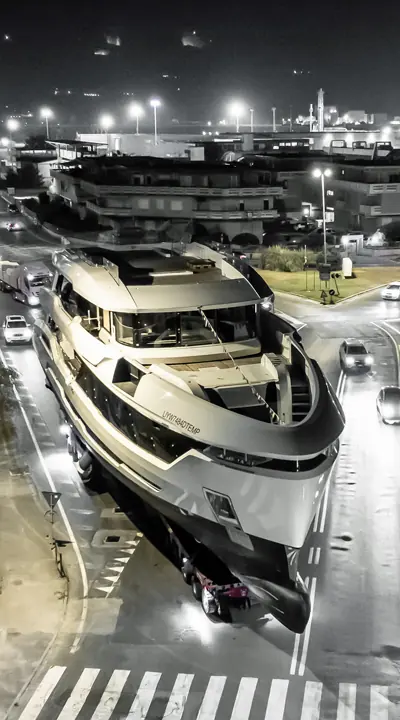 Cadet under tow through La Spezia's streets on the night before her launch, still carrying her temporary IMO registration marking on the hull.