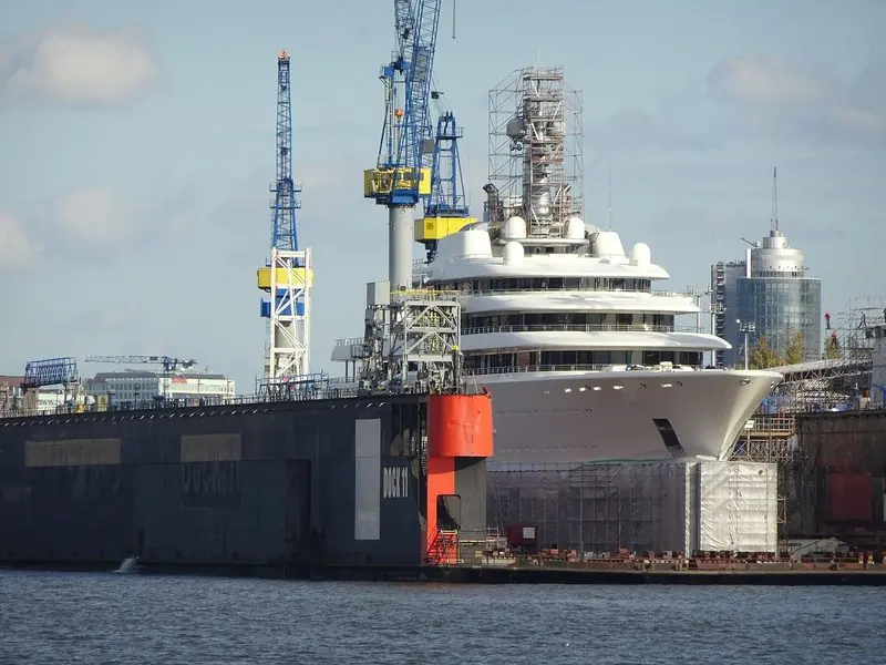 Scaffolding and yard cranes close around Eclipse in Dock 11 at Hamburg.