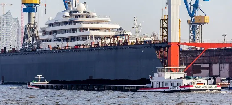 A loaded barge passes the Hamburg floating dock where Eclipse is laid up.