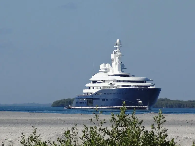 Mangrove scrub frames Al Mirqab as she moves along a low shoreline in Cuba.