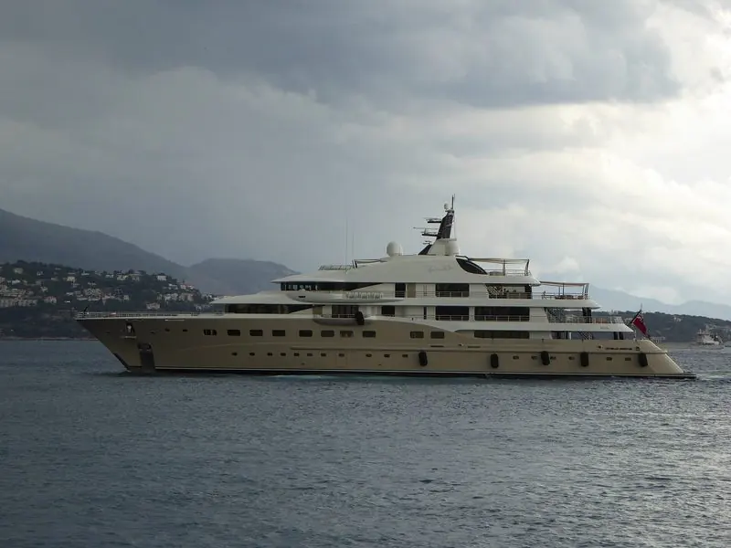 Heavy cloud hangs over the coast as Here Comes The Sun runs slowly off Monaco.