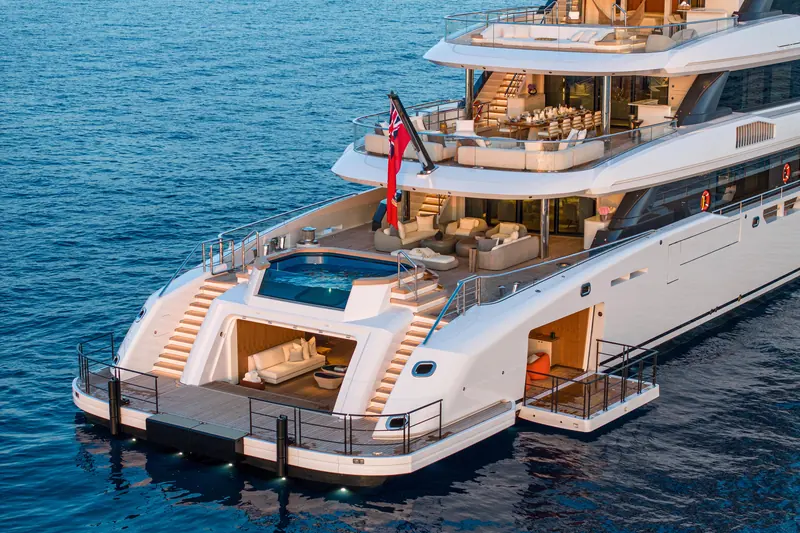 Infinite Jest at anchor at dusk, showing the aft plunge pool and lower deck of the 75 metre Turquoise-built, Vallicelli-styled explorer.