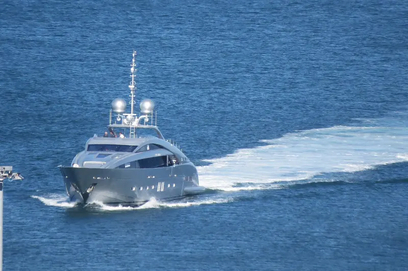 Silver Wind entering Ancona harbour past the breakwater, her name visible on the hull, with ISA's home yard in the background.