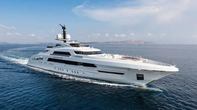 Galactica Star underway off Sardinia, the fine, slender bow and low, continuous sheerline of the FDHF visible from the bow quarter.
