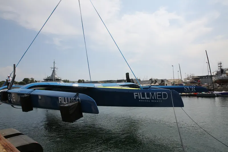 SVR-Lazartigue, Francois Gabart's VPLP-designed Ultim trimaran, craned out at the CDK Technologies yard in Lorient; five of the six boats in the 2024 Arkea Ultim Challenge fleet were VPLP designs.