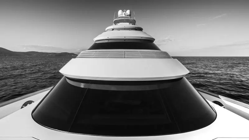 Seen from the bow in black and white, the deckhouse stacks in tiers below the mast.