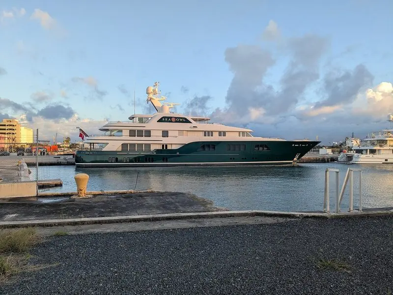 Evening light warms the green hull of Sea Owl at her berth in Puerto Rico.