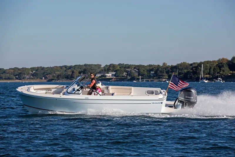 A Vanquish 26 under way with an outboard tucked under the transom, one of the smaller center-console designs in Zurn's portfolio.