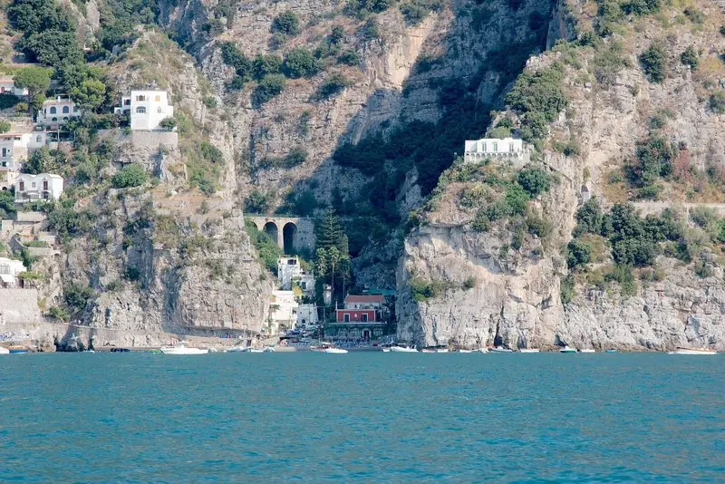 The Amalfi coast from the water, cliffs falling straight into deep blue.
