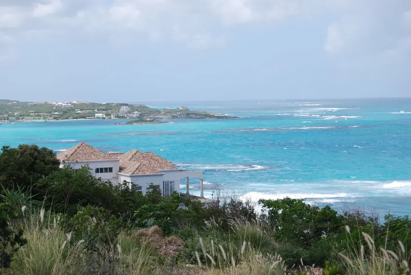 The reef line off Island Harbour, seen from the bluff above Scilly Cay, where the barrier breaks the Atlantic swell before it reaches the anchorage.