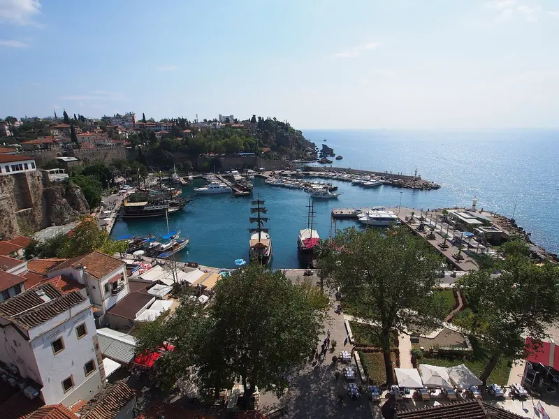 Boats moored in Antalya's historic Roman-era harbour, below the old town walls.