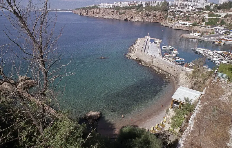 Antalya's harbour and coastline seen from above, where the city meets the Mediterranean.