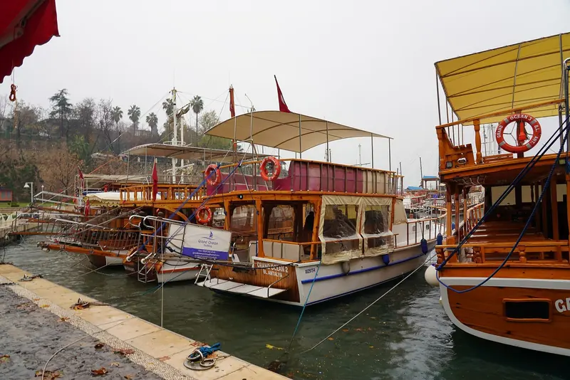 Traditional wooden excursion boats moored in Antalya's old harbour.