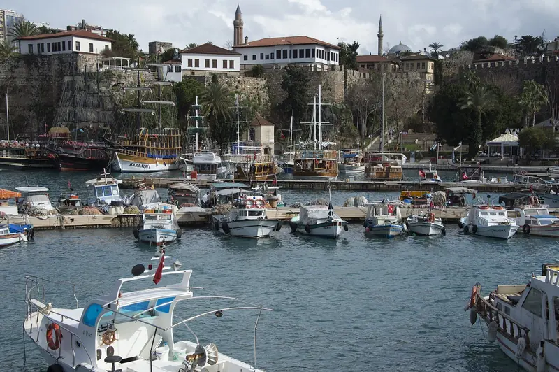 Boats crowd Antalya's old harbour beneath the town's historic quarter.