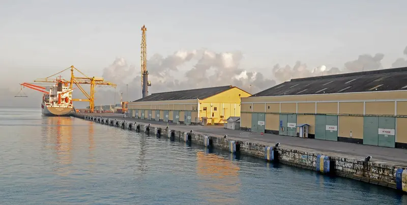 A cargo ship works the quay at Deep Water Harbour, the working port that handles vessels beyond Port St Charles' capacity.