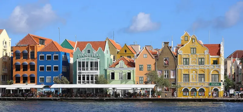 Dutch colonial facades on Handelskade, including the Penha Building, dated to 1708.