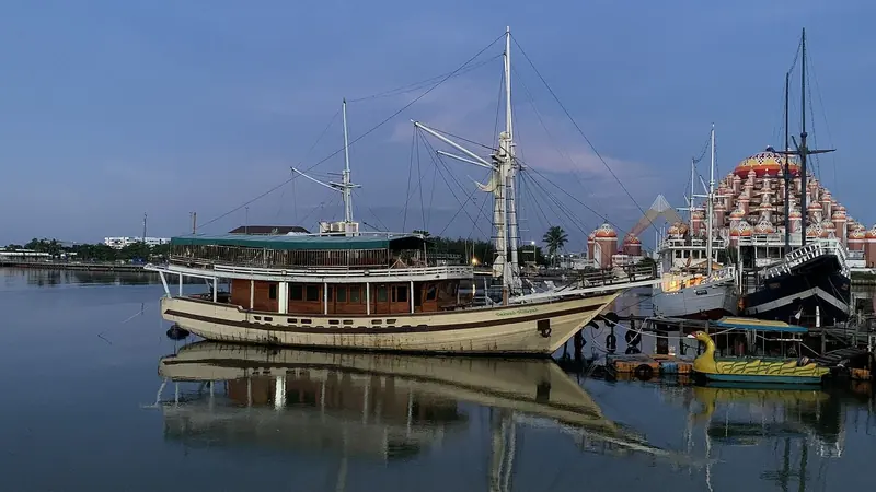 A phinisi moored close to shore, the traditional wooden hull form Celestia shares.