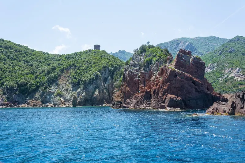 A Genoese watchtower on the rock above the bay of Elbo, one of a chain built to signal the length of the coast.