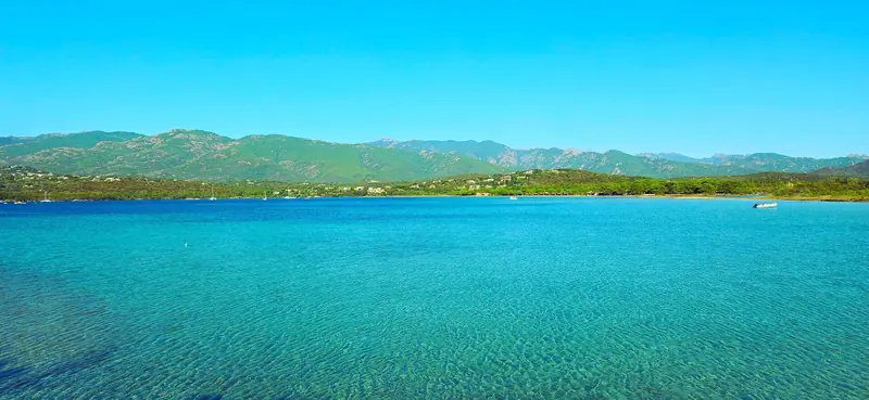 The Gulf of Porto-Vecchio, shallow, sheltered and green edged, at the smart resort end of southern Corsica.