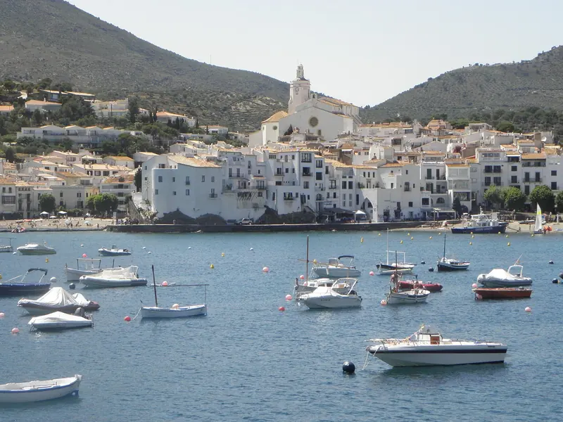 Cadaques from above the village, boats lying to moorings in the bay under the church, at the northern end of the Costa Brava.