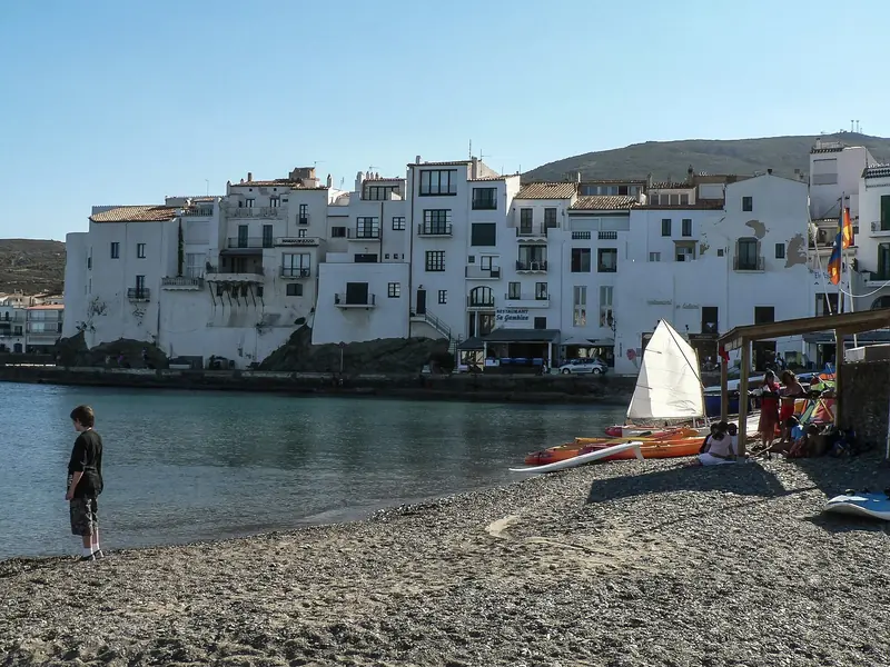 Whitewashed houses come down to the water at Cadaques, slate paved and hemmed in by the hills of Cap de Creus behind.
