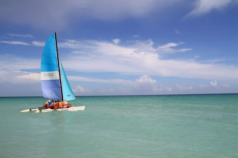 A Hobie Cat runs out from a Varadero beach, the small-boat sailing that fills the resort coast while yacht traffic stays mostly to Havana and the cays.