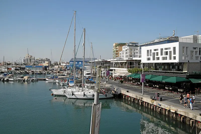 Limassol Marina, the only south-coast facility built for large yachts, with sailboats on the pontoons and the town's waterfront apartments behind.