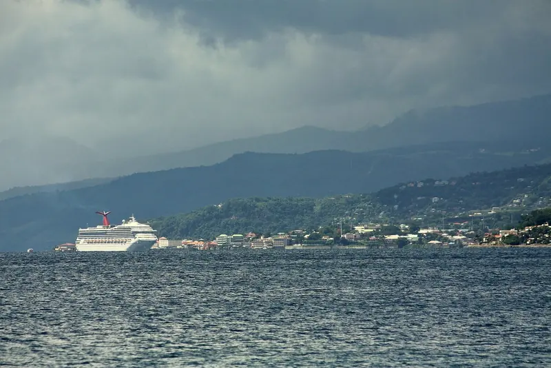 A cruise ship lies off Roseau, Dominica's capital and steep-to southern anchorage, hills rising straight from the shoreline.