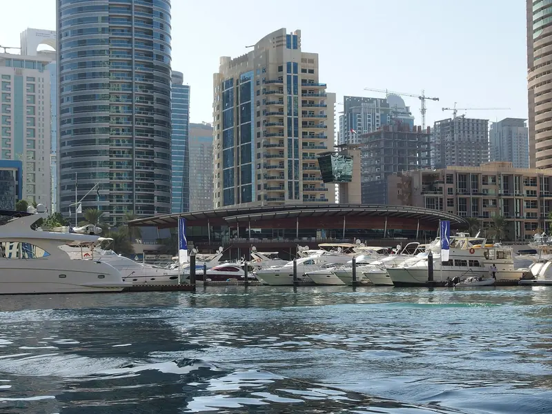 Motor yachts on a Dubai pontoon under the towers, in an emirate that has built berthing from 10 metres to over 100 since 2010.