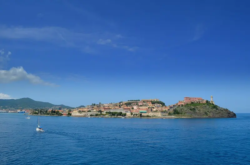 Portoferraio's fortress walls from the sea, the approach every boat into the harbour still makes. The Medici built these walls against Barbary raids in the 1540s; Napoleon inherited them as a head of state with 400 or so subjects to govern.