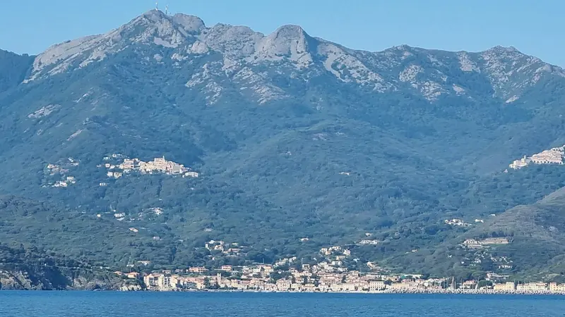Marciana Marina, on Elba's quieter west coast, 115 berths behind a breakwater and a genuinely different pace from Portoferraio's summer traffic.