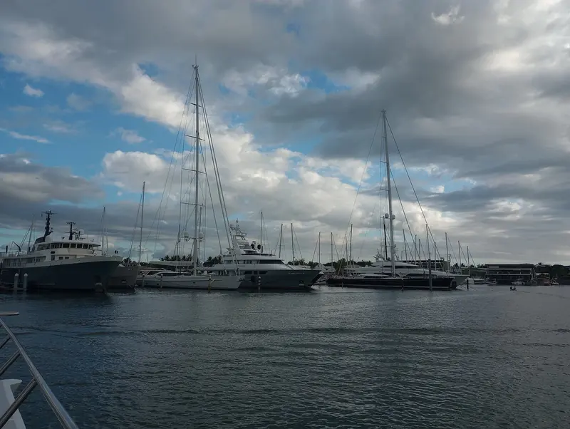 Port Denarau Marina at evening, motor yachts and sailing yachts on the same pontoons