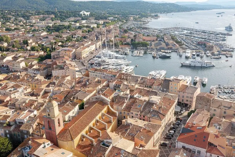 Saint-Tropez from above, the old port packed and the fleet lying off the town.