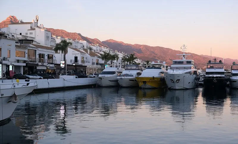 The inner quay at Puerto Banus, restaurants on one side and boats on the other, twenty minutes from the Gibraltar frontier by road.