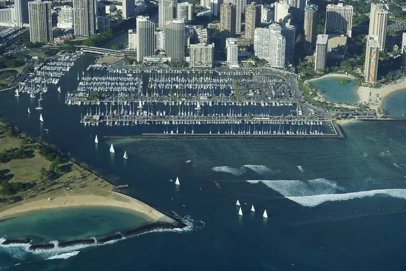 A sailboat threads the Ala Wai Harbor entrance channel, the only way in or out of Hawaii's largest small-boat harbor.