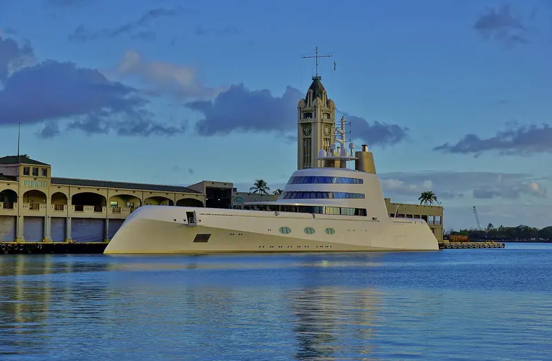 The 119-metre motor yacht A, built for Andrey Melnichenko, moored at Pier 11 in Honolulu Harbor beneath the 1926 Aloha Tower.