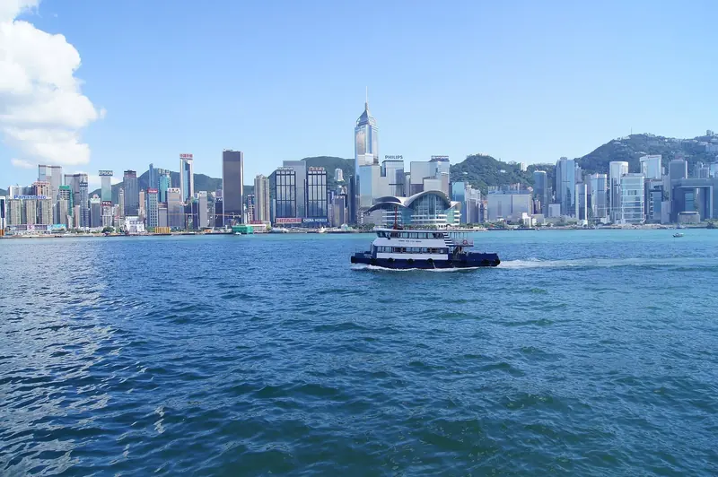 The Star Ferry crosses Victoria Harbour with the Hong Kong Island skyline behind it, the anchorage that every yacht arriving from the South China Sea has to thread through.