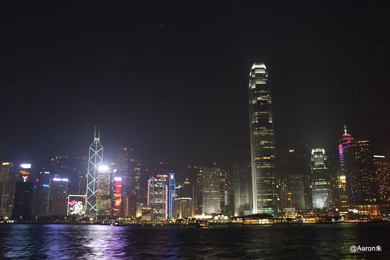 Victoria Harbour after dark, the container-port and financial-centre skyline that frames every passage between the Hong Kong side and Kowloon.