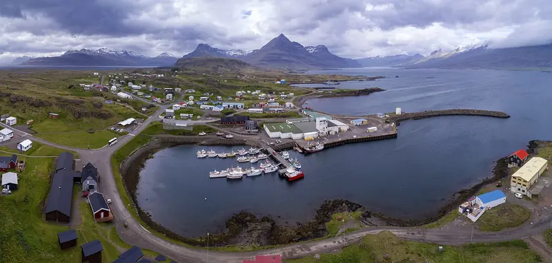 Djupivogur, a working harbour on Iceland's southeast coast, seen from the air. Small ports like this one, not a resort marina, are what a boat actually ties up to on a circumnavigation of Iceland.