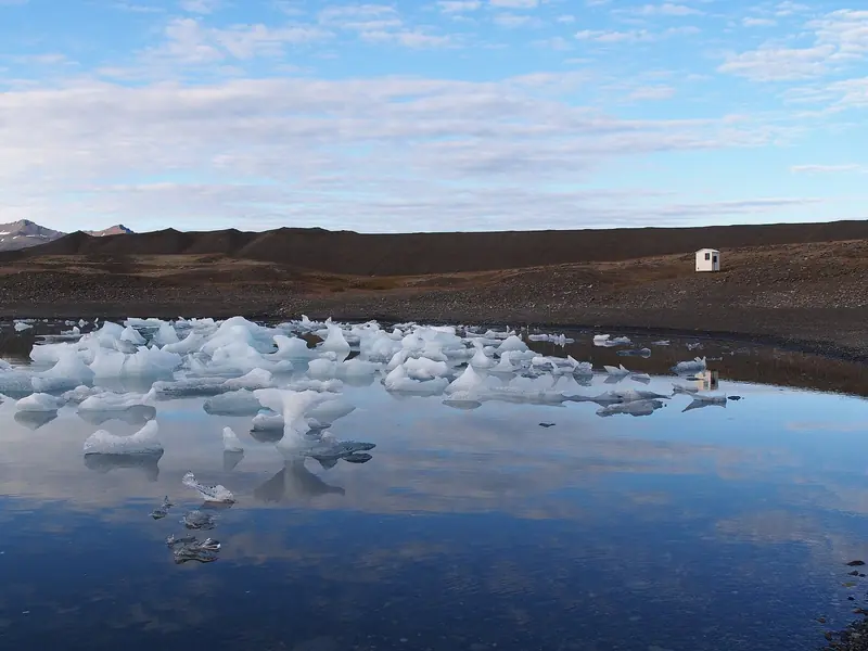 The stony coast beside Jokulsarlon glacier lagoon on the south shore. The lagoon itself is landlocked and not reachable by yacht, but the coastal water off it is a working part of the south-coast passage.