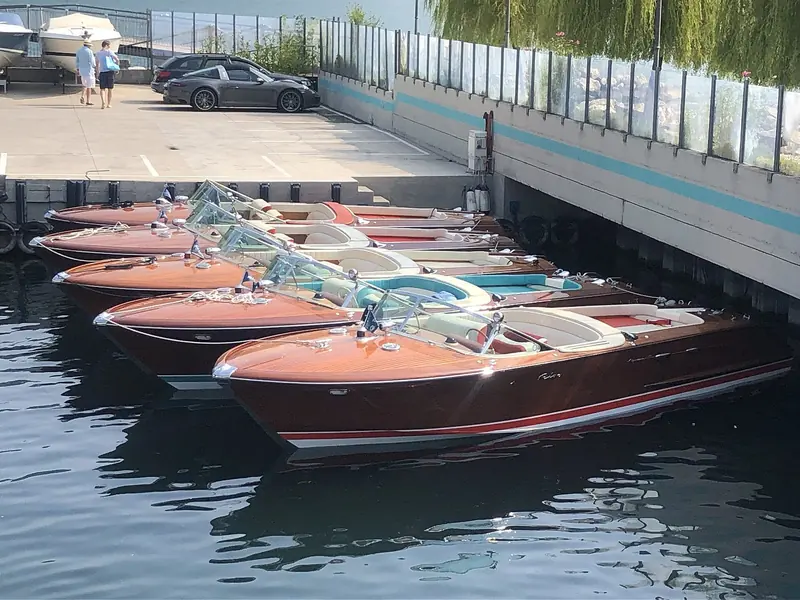 Riva Aquaramas rafted together at a Lake Garda dock. The style was set an hour away at the Riva yard on Lake Iseo, but the boats themselves live on Como and Garda in the hundreds.