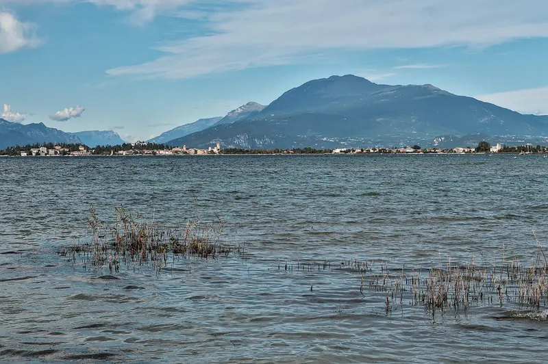 Sirmione and Monte Baldo across Lake Garda, seen from Rivoltella on the lake's southern shore.