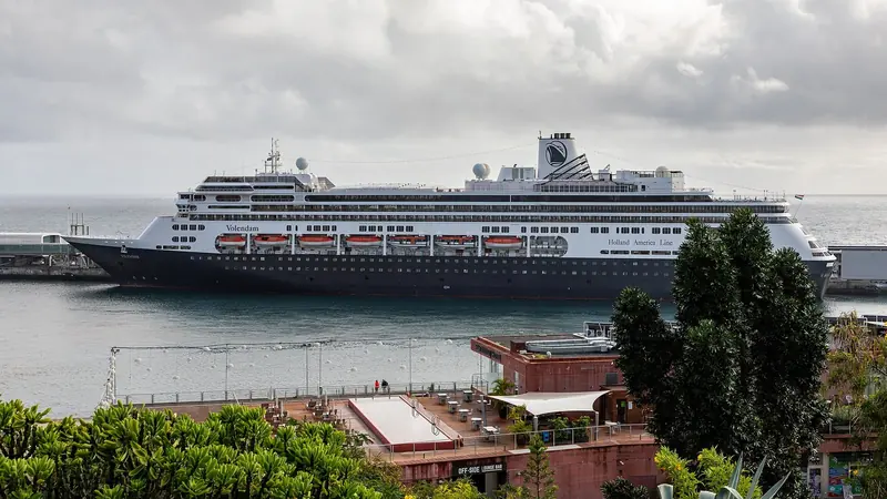 Holland America's Volendam swings off the pier head into Funchal harbour, the working waterfront that shares the port with visiting yachts.
