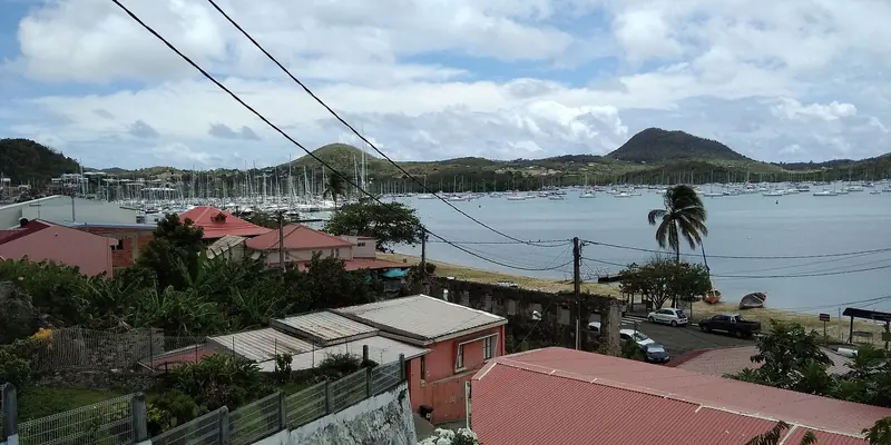 Le Marin's bay, seen from the forecourt of the Eglise Saint-Etienne, is crowded with sailboats at anchor and on moorings below the town.