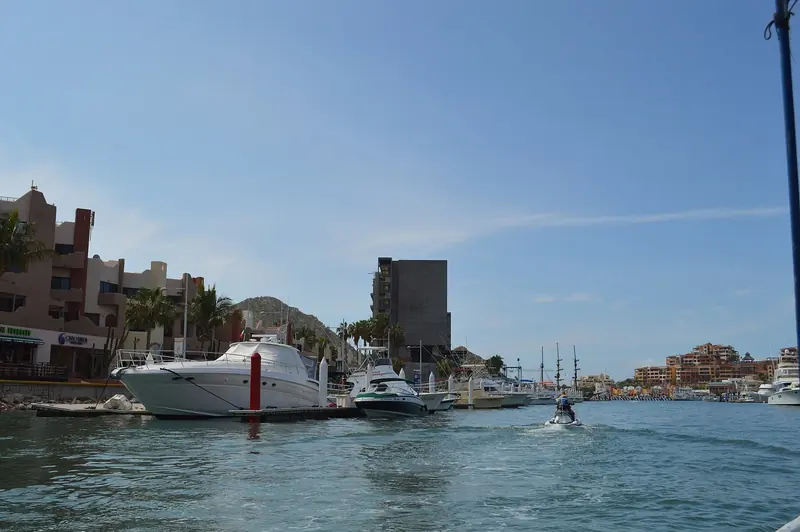 Cabo San Lucas marina, the harbour every Baja yacht charter and sportfishing fleet works out of, with El Arco visible beyond the breakwater.
