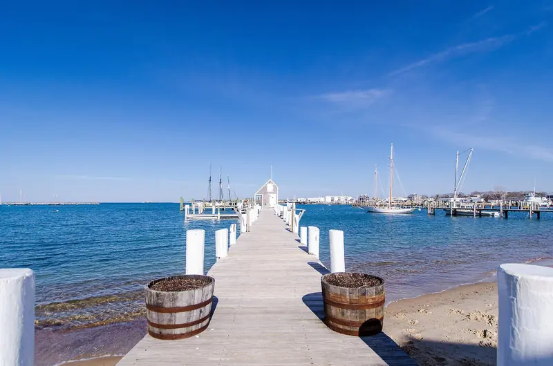 A harbor dock on Martha's Vineyard, with schooners and sailboats moored alongside.