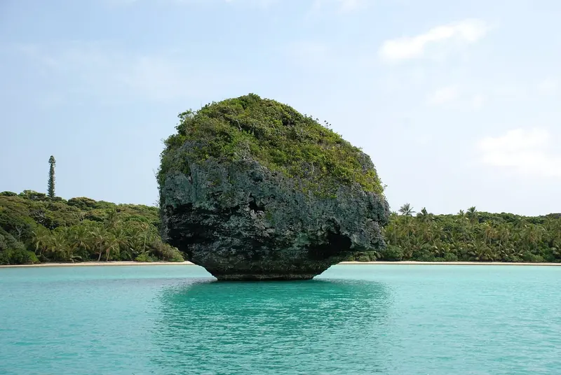 Le Bonhomme, a mushroom-shaped limestone islet in the turquoise shallows off the Ile des Pins, one of the reasons cruisers push south from Noumea rather than stopping at the capital.