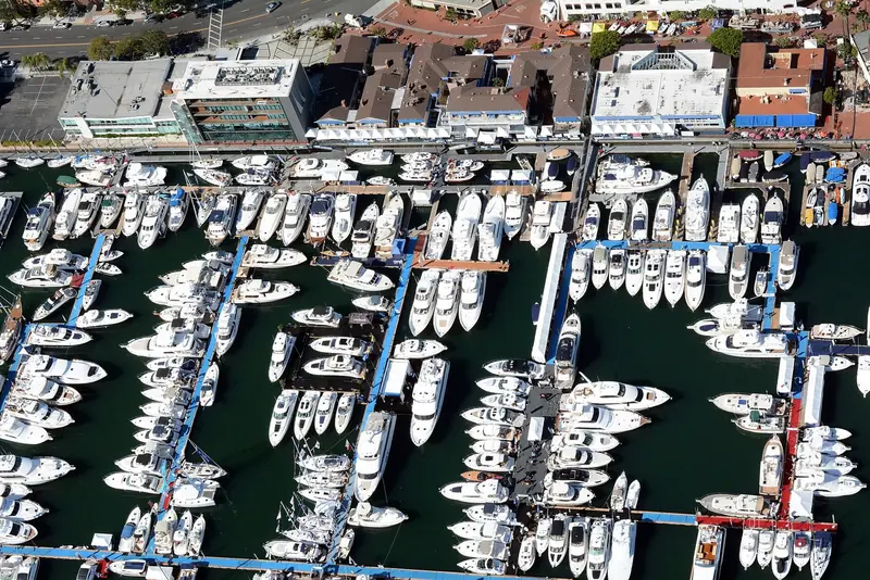 Docks packed for the Newport Beach Boat Show, seen from above against the harborfront shops.