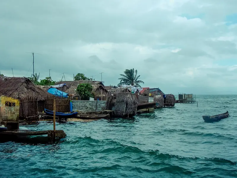 A Guna village of thatch and cane built out over the water, on islands whose congress collects USD 20 a head a month from visiting boats.